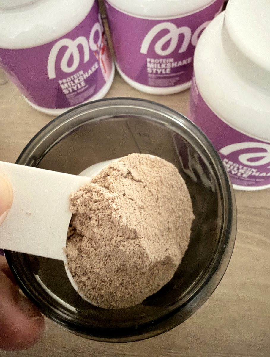 Gestrichener Messlöffel mit Iced-Coffee-Pulver über einem Shaker